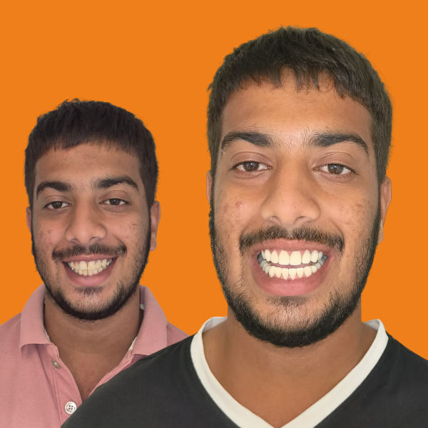 Two smiling men pose for the camera against an orange background.