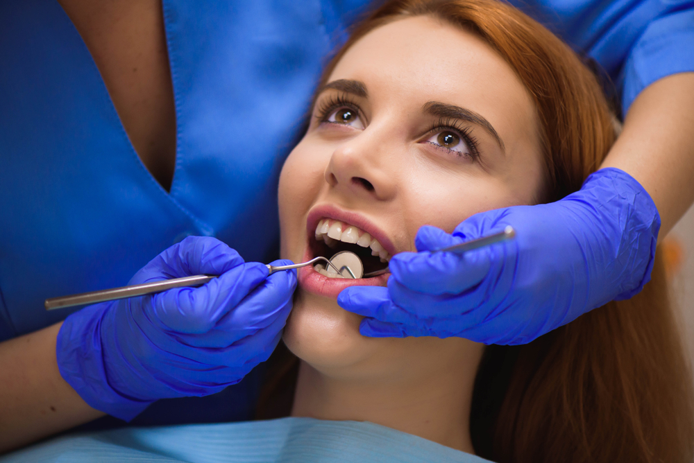Dentist examining gum health during a dental check-up at Age Concepts Navi Mumbai